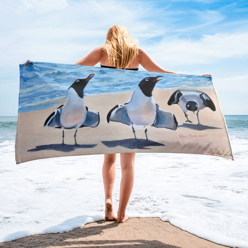 A Woman posing with towel on the beach